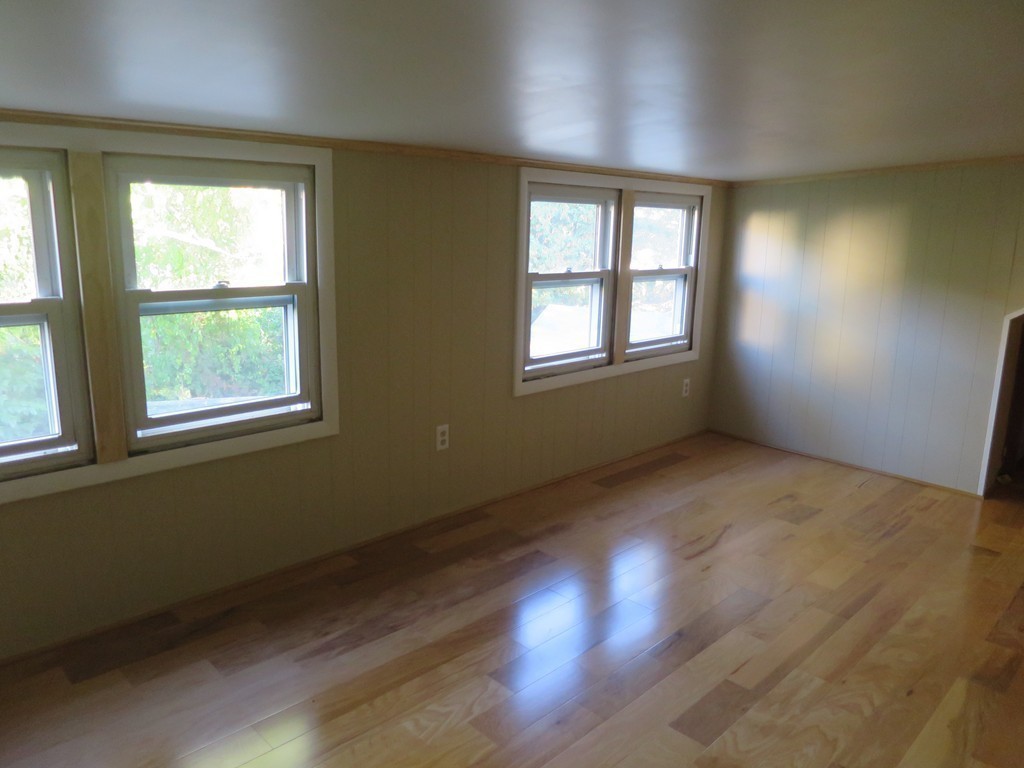 21 Coache Street Three Rivers, MA 01080 - Photo 8 of 20 an empty room with wooden floor and windows