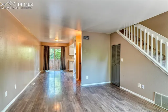 a view of a hallway view with wooden floor and staircase