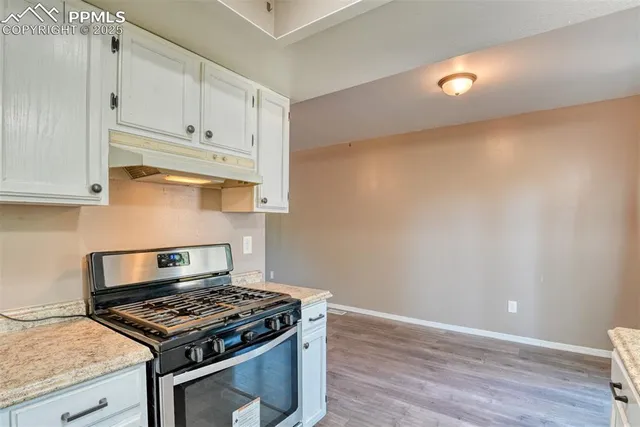 a stove top oven sitting inside of a kitchen