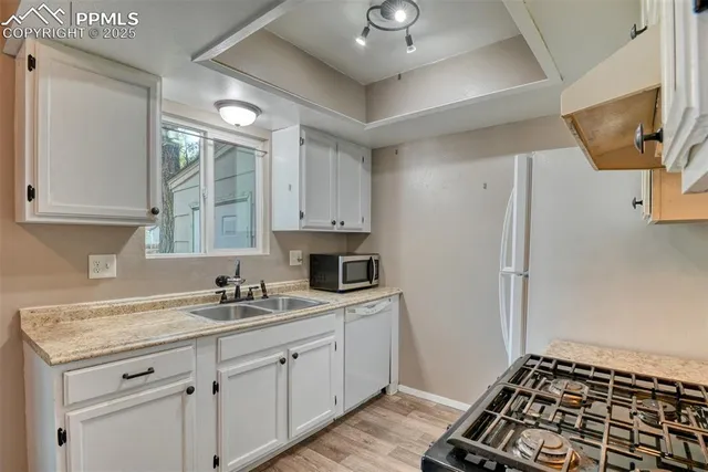 a kitchen with sink cabinets and appliances