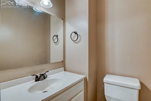 a bathroom with a toilet a sink and mirror