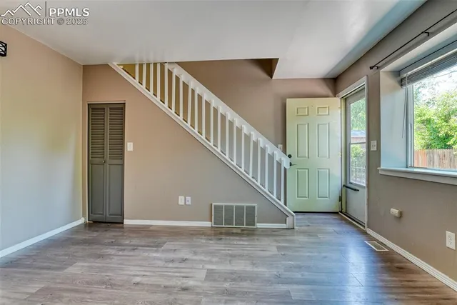 a view of entryway and hall with wooden floor
