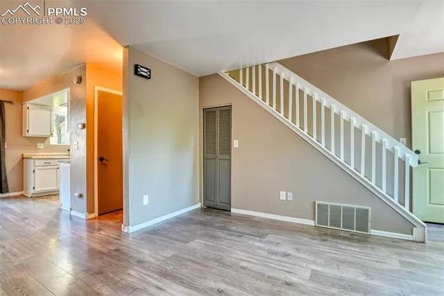 a view of entryway and hall with wooden floor