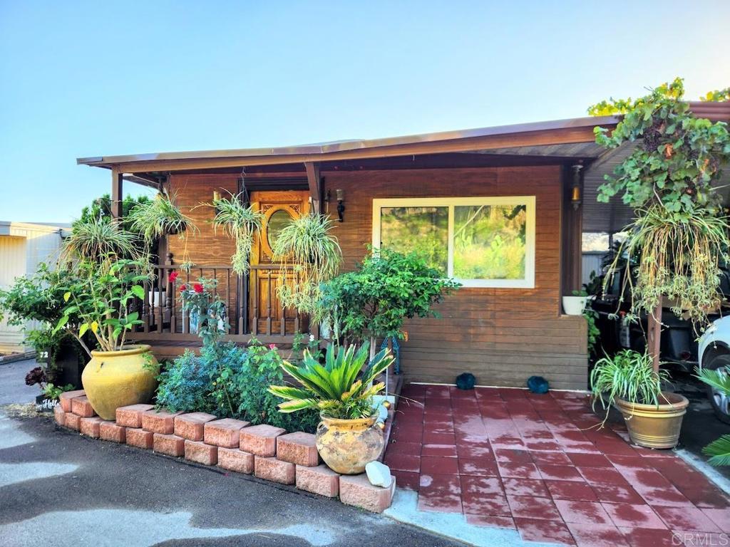 1200 Grand Avenue, Unit 72 Spring Valley, CA 91977 - Photo 1 of 1 a potted plant sitting in front of a house