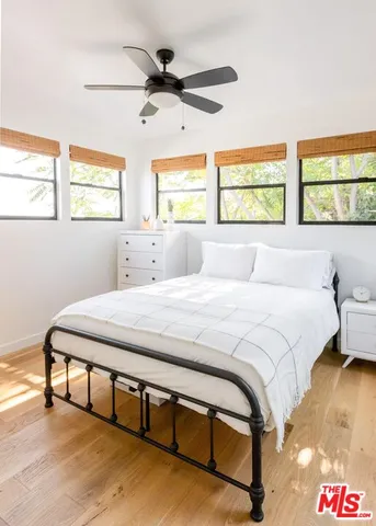 a bedroom with a bed and a large window