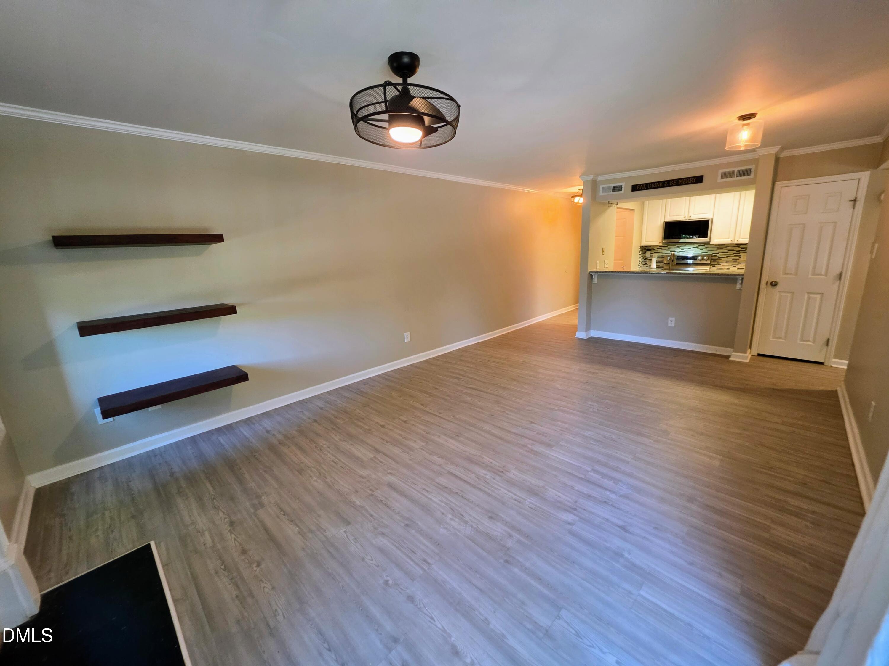 3803 Chimney Ridge Place, Unit 4 Durham, NC 27713 - Photo 5 of 16 a view of a kitchen with wooden floor and electronic appliances