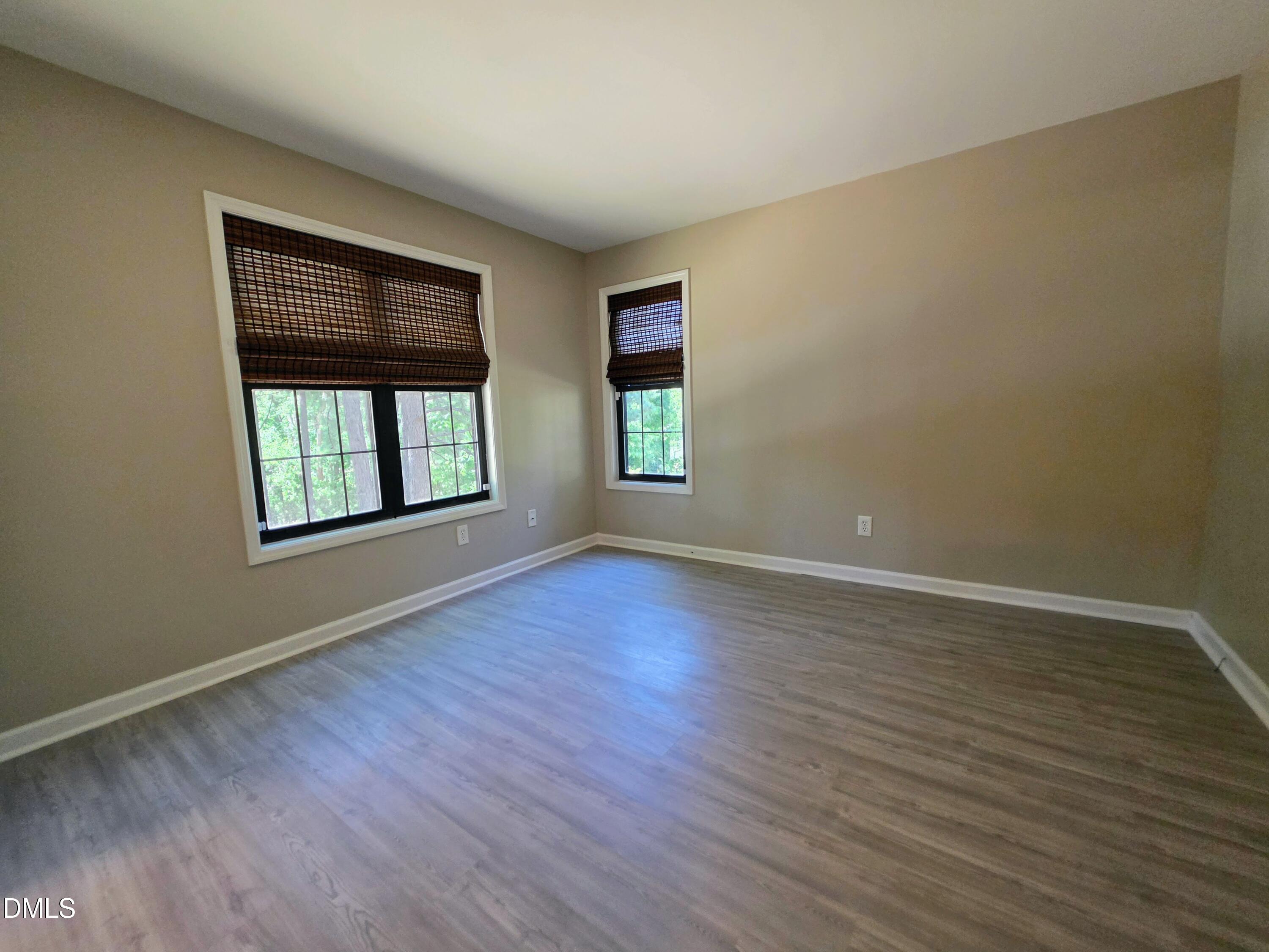 3803 Chimney Ridge Place, Unit 4 Durham, NC 27713 - Photo 8 of 16 a view of an empty room with wooden floor and a window