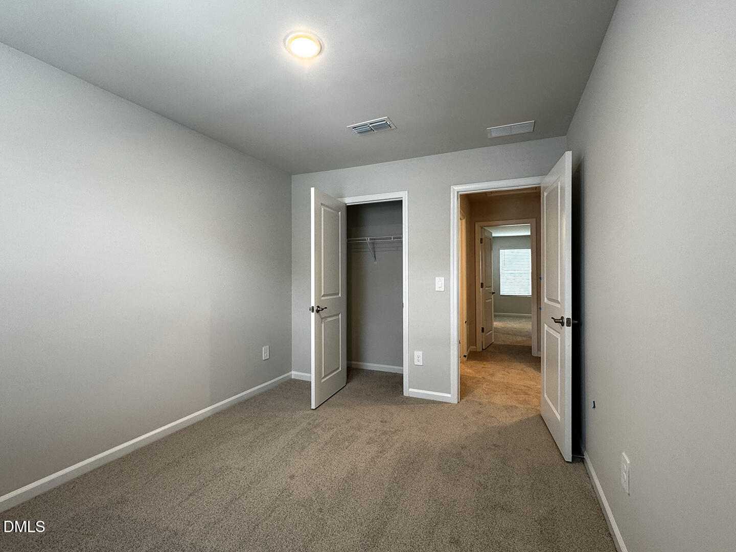 1007 Winding Spg Drive Mebane, NC 27302 - Photo 21 of 32 an empty room with closet and a hallway