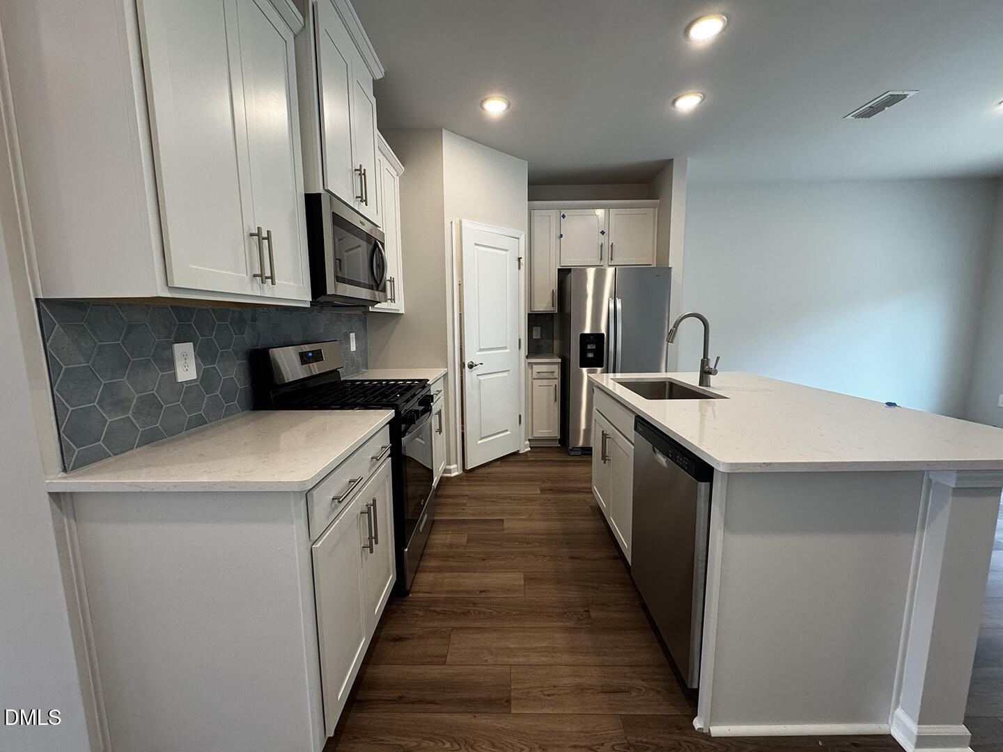 1007 Winding Spg Drive Mebane, NC 27302 - Photo 7 of 32 a kitchen with cabinets and stainless steel appliances