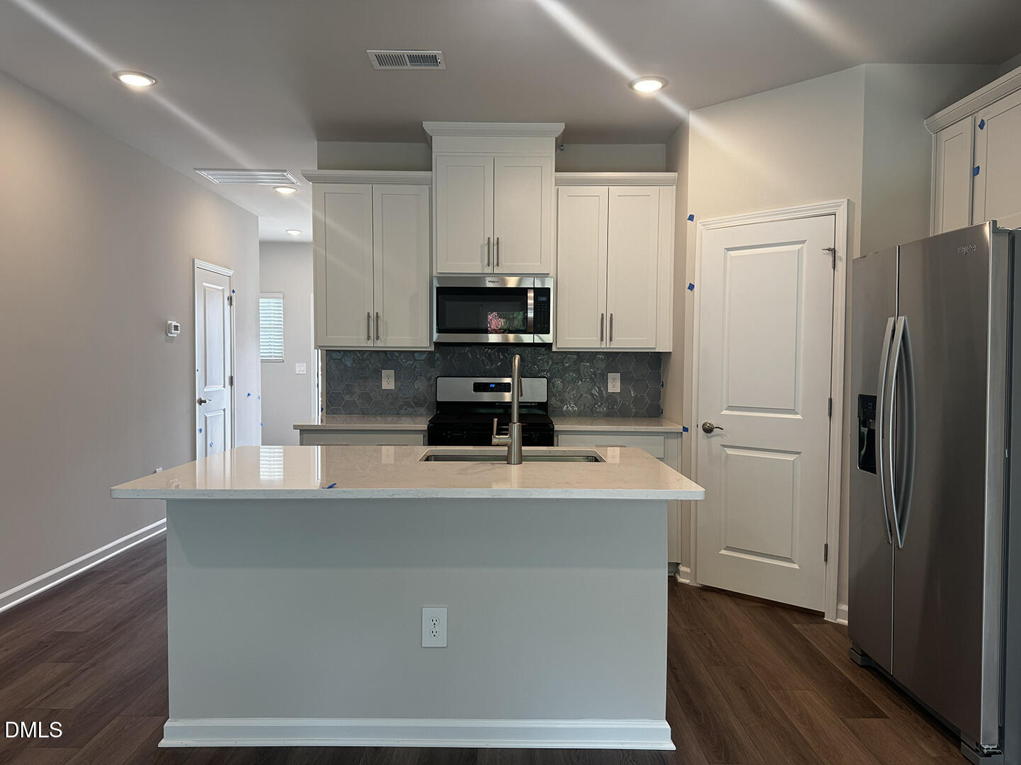 1007 Winding Spg Drive Mebane, NC 27302 - Photo 9 of 32 a kitchen with stainless steel appliances a refrigerator stove microwave and cabinets
