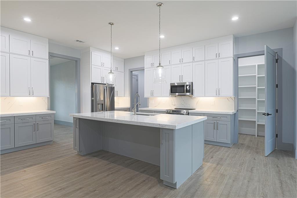 1341 Wheeler Creek Road Maysville, GA 30558 - Photo 17 of 65 a large kitchen with kitchen island a sink stainless steel appliances and cabinets