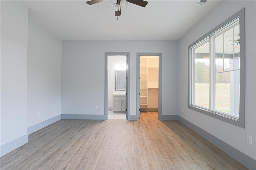 1341 Wheeler Creek Road Maysville, GA 30558 - Photo 32 of 65 an empty room with wooden floor and windows
