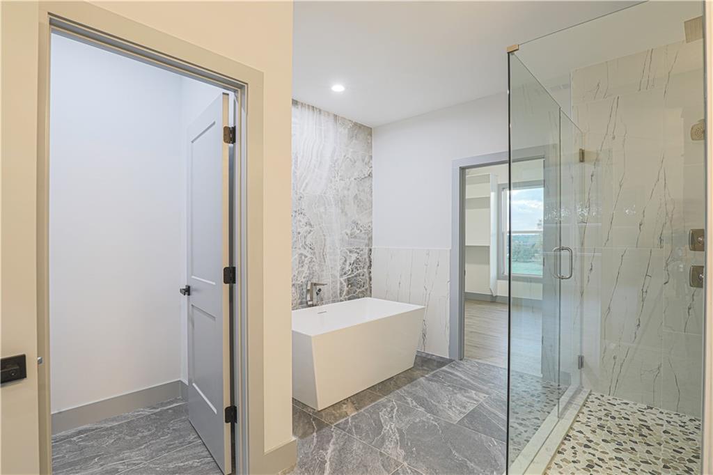 1341 Wheeler Creek Road Maysville, GA 30558 - Photo 4 of 65 a bathroom with a tub shower and sink