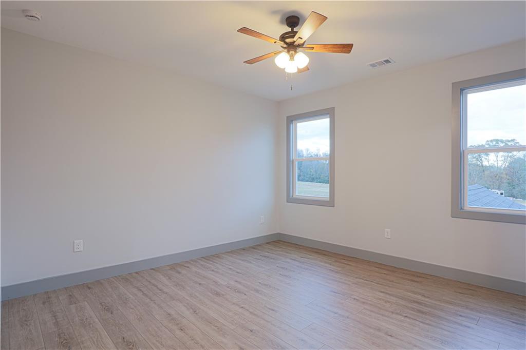 1341 Wheeler Creek Road Maysville, GA 30558 - Photo 43 of 65 an empty room with a window and a fan
