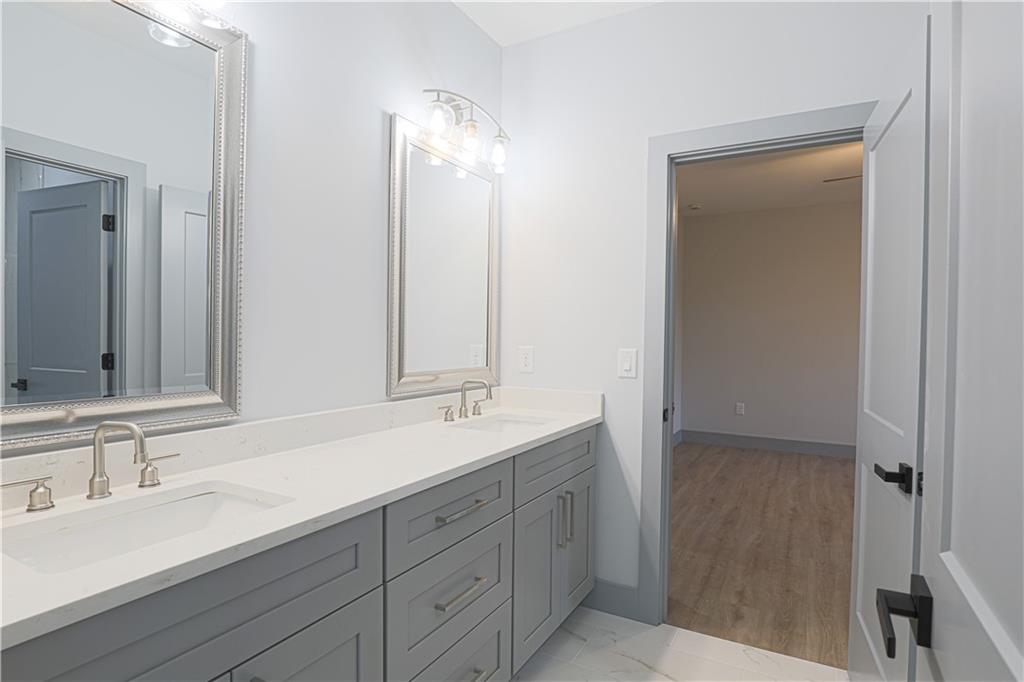 1341 Wheeler Creek Road Maysville, GA 30558 - Photo 45 of 65 a bathroom with double vanity sink and a mirror