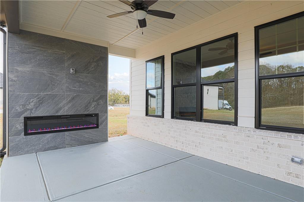 1341 Wheeler Creek Road Maysville, GA 30558 - Photo 5 of 65 a living room with fireplace and a large window