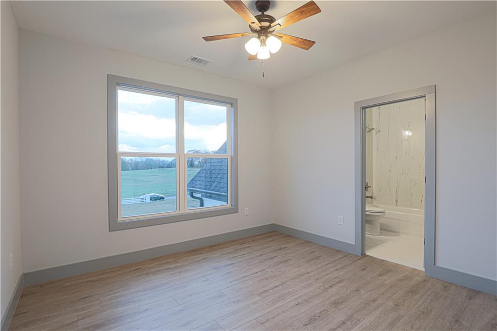 1341 Wheeler Creek Road Maysville, GA 30558 - Photo 52 of 65 an empty room with wooden floor and a window