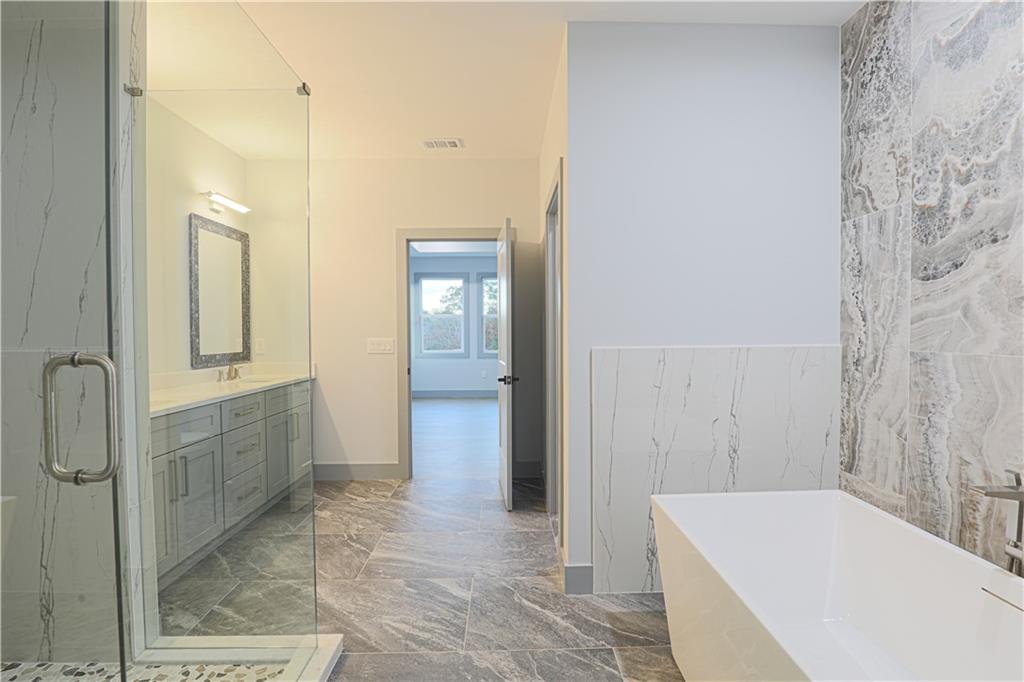 1341 Wheeler Creek Road Maysville, GA 30558 - Photo 59 of 65 a bathroom with a bathtub and shower