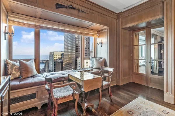 a room with lots of books and a window