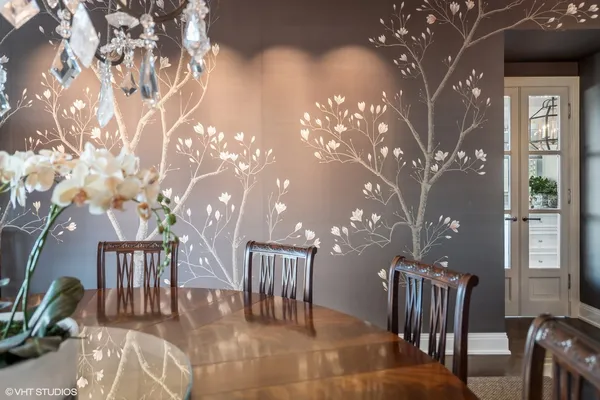 a view of a big room with a dining table and chairs