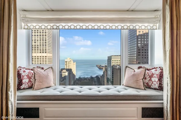 a bathroom with a bathtub and a large window