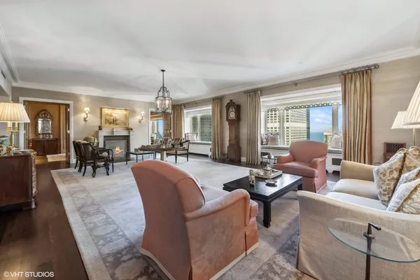 a living room with furniture and a chandelier