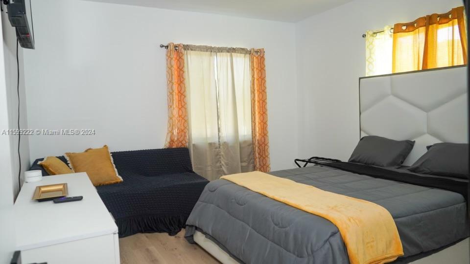 1254 Southwest 13th Street, Unit 1254 Miami, FL 33145 - Photo 11 of 14 a bedroom with a bed and wooden floor