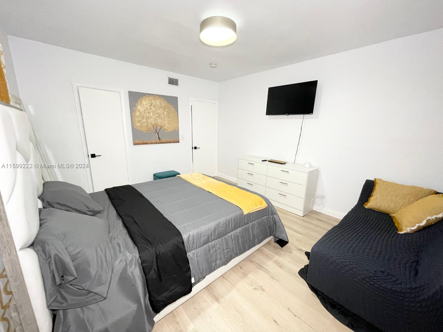 1254 Southwest 13th Street, Unit 1254 Miami, FL 33145 - Photo 12 of 14 a bedroom with a bed and a flat tv screen