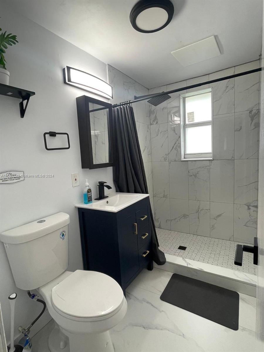 1254 Southwest 13th Street, Unit 1254 Miami, FL 33145 - Photo 13 of 14 a bathroom with a sink toilet and shower