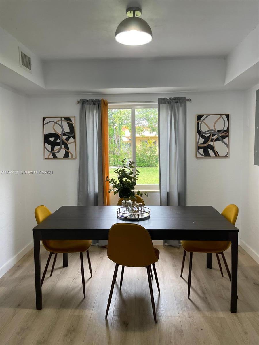1254 Southwest 13th Street, Unit 1254 Miami, FL 33145 - Photo 9 of 14 a view of a dining room with furniture window and wooden floor