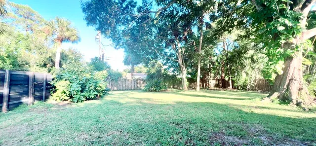 a backyard of a house with a yard and outdoor seating