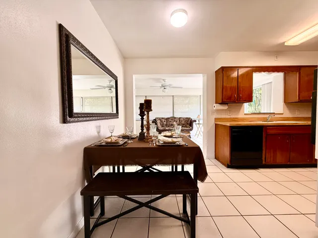 a view of a dining room with furniture and window