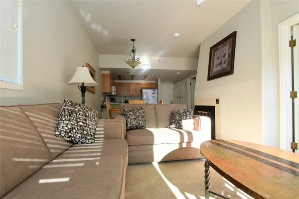a living room with furniture and kitchen view