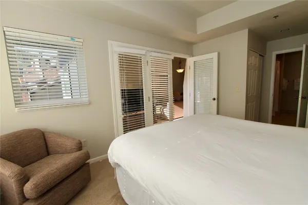 a bedroom with a bed couch and a window