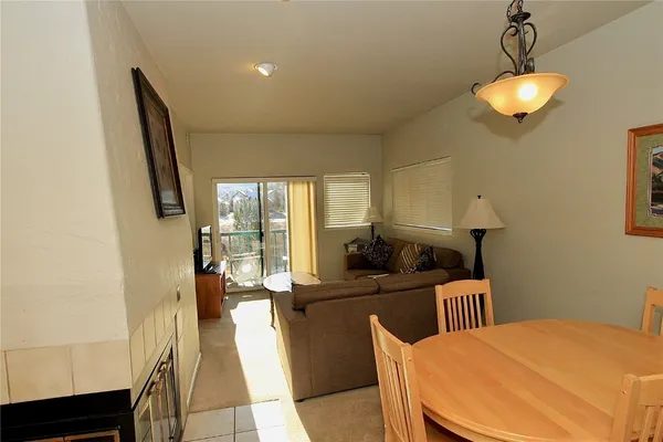 a kitchen with a table chairs refrigerator and a sink
