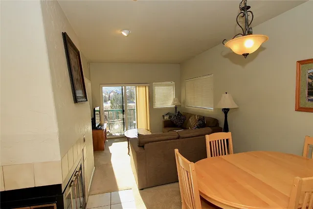 a kitchen with a table chairs refrigerator and a sink