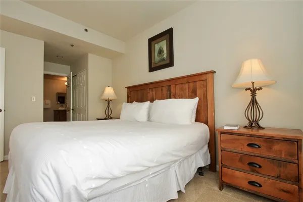 a bedroom with a bed and a dresser
