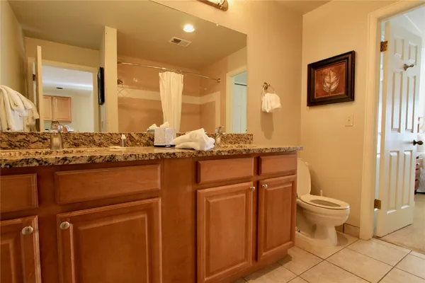a bathroom with a sink a toilet and mirror