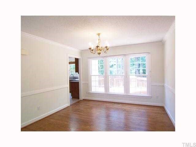 6617 Rainwater Road Raleigh, NC 27615 - Photo 3 of 12 The formal Dining Rm w/crown & chair rail molding, hrdwd flr & brass chandelier is open to the Living Rm, and adjacent is the vaulted KIT.
