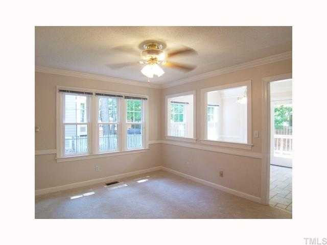 6617 Rainwater Road Raleigh, NC 27615 - Photo 4 of 12 The cozy Family Rm has neutral carpet, ceiling fan, crown & chair rail molding, and a door to the attached 2-car Garage w/workbench & electric door opener. It has 2 passthrus to the B'fast Rm.