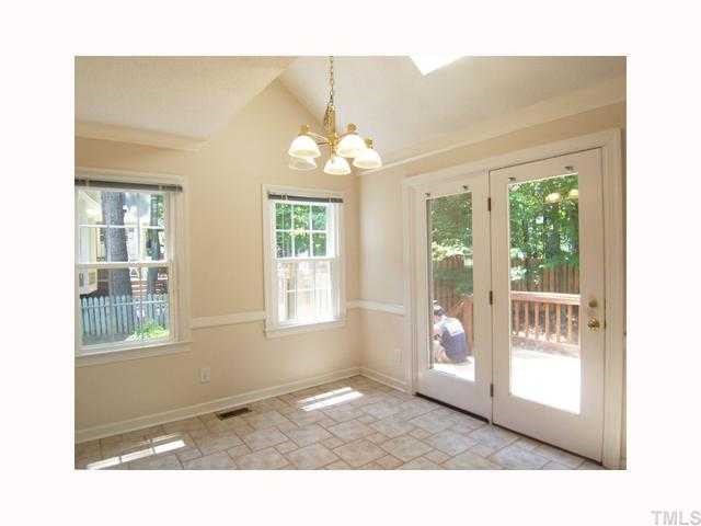 6617 Rainwater Road Raleigh, NC 27615 - Photo 5 of 12 View of the vaulted B'fast Rm w/skylights, stone-look ceramic tile flr, French dr to the Deck & passthru openings to the Family Rm.