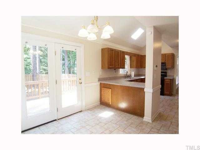 6617 Rainwater Road Raleigh, NC 27615 - Photo 6 of 12 View of the vaulted B'fast Rm & Kitchen, both w/skylights & stone-look- ceramic tile floor.