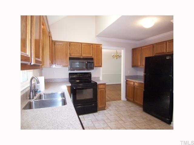 6617 Rainwater Road Raleigh, NC 27615 - Photo 7 of 12 The bright KIT offers lots of oak cabinets, granite-look solid surface counters, eat-at peninsula, black appliances including smooth-top range w/self-clean oven, microwave & dishwasher, disposal, pantry & track lighting.