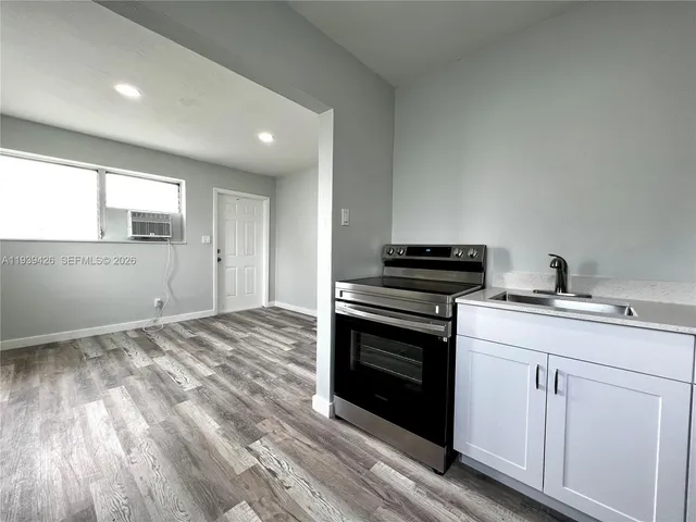 a kitchen with a stove and a sink
