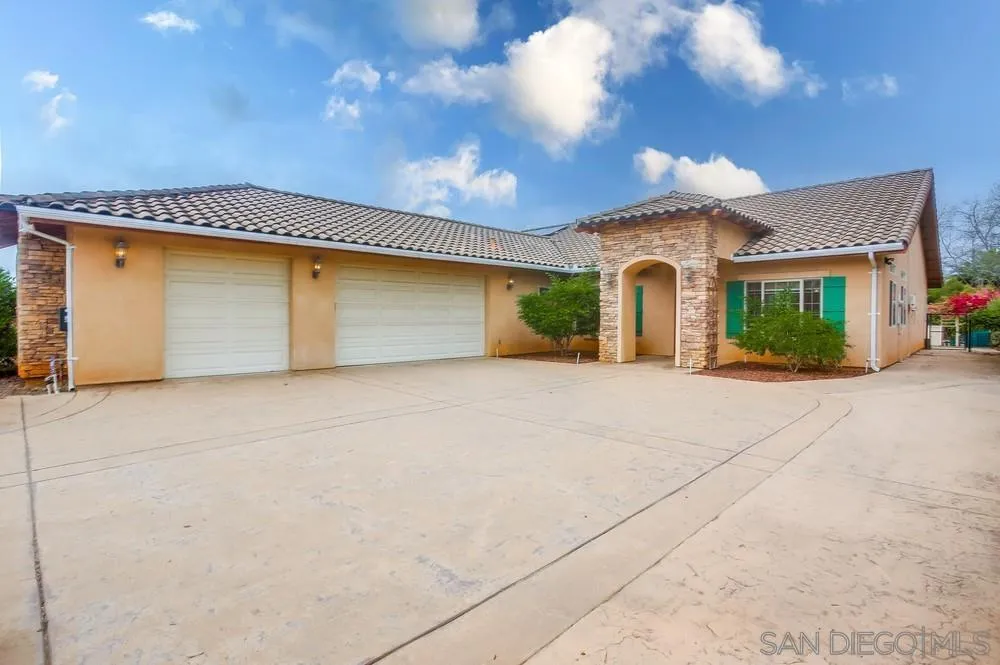 a view of a house with a yard and garage