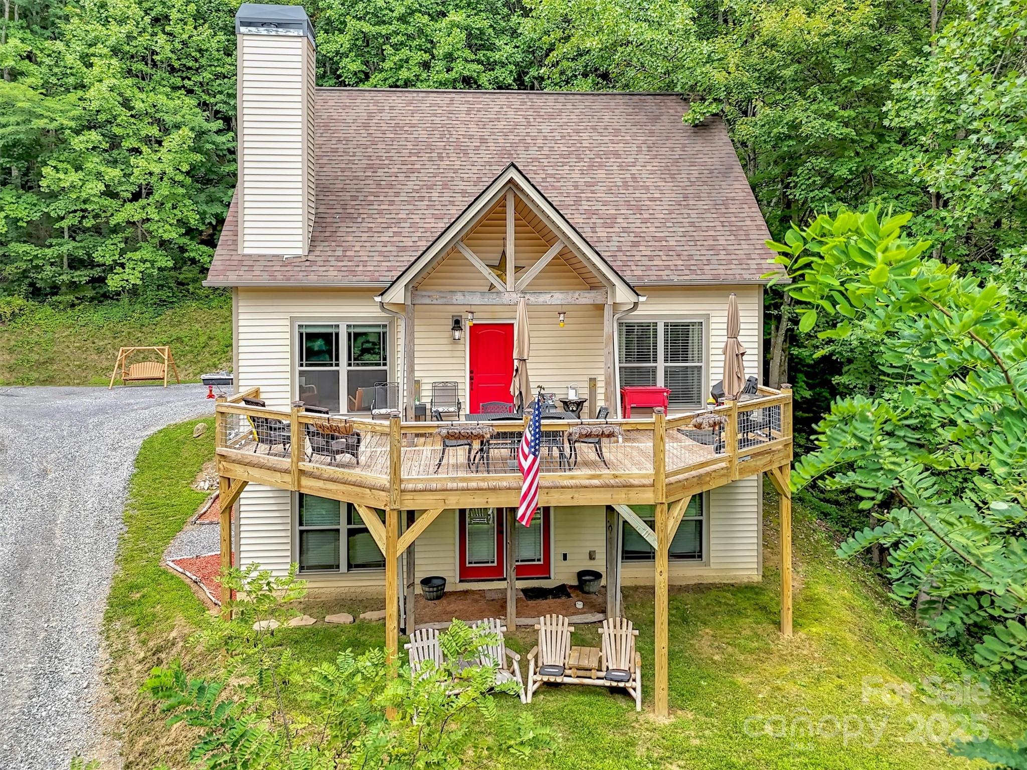 a view of a house with backyard porch and sitting area