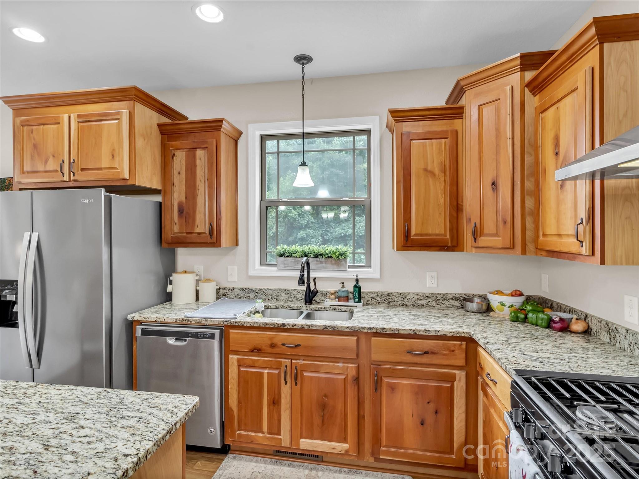4823 Max Patch Road Clyde, NC 28721 - Photo 11 of 47 a kitchen with stainless steel appliances granite countertop a sink stove and refrigerator