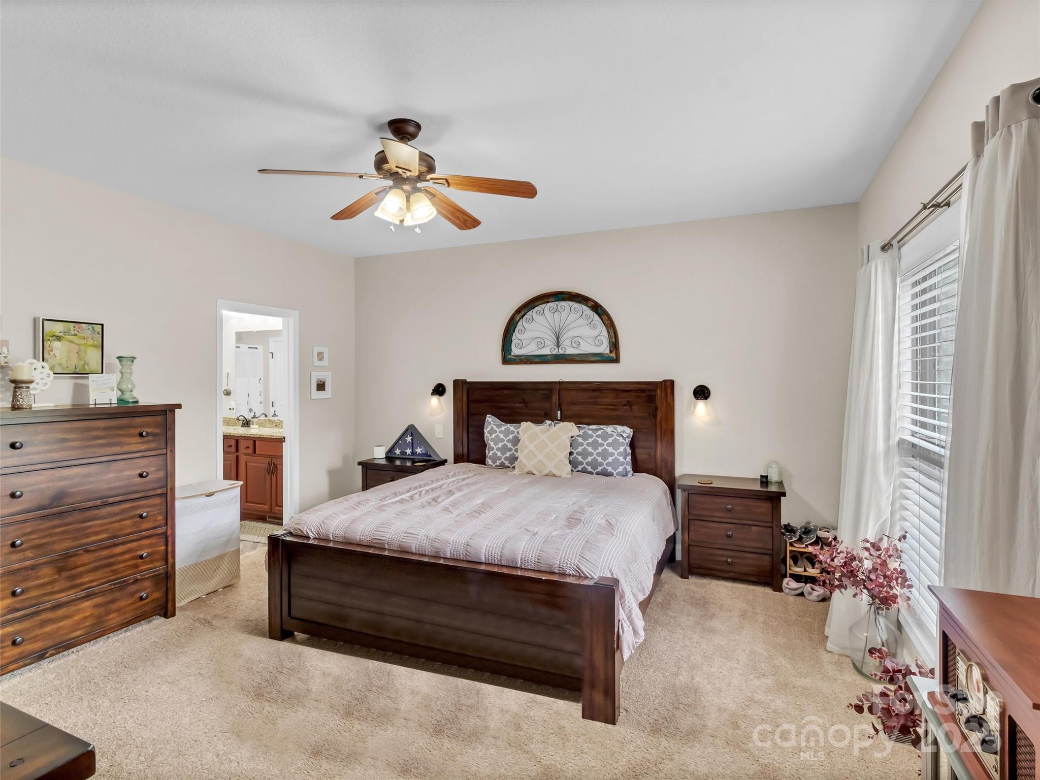 4823 Max Patch Road Clyde, NC 28721 - Photo 15 of 47 a bedroom with a bed and a chandelier