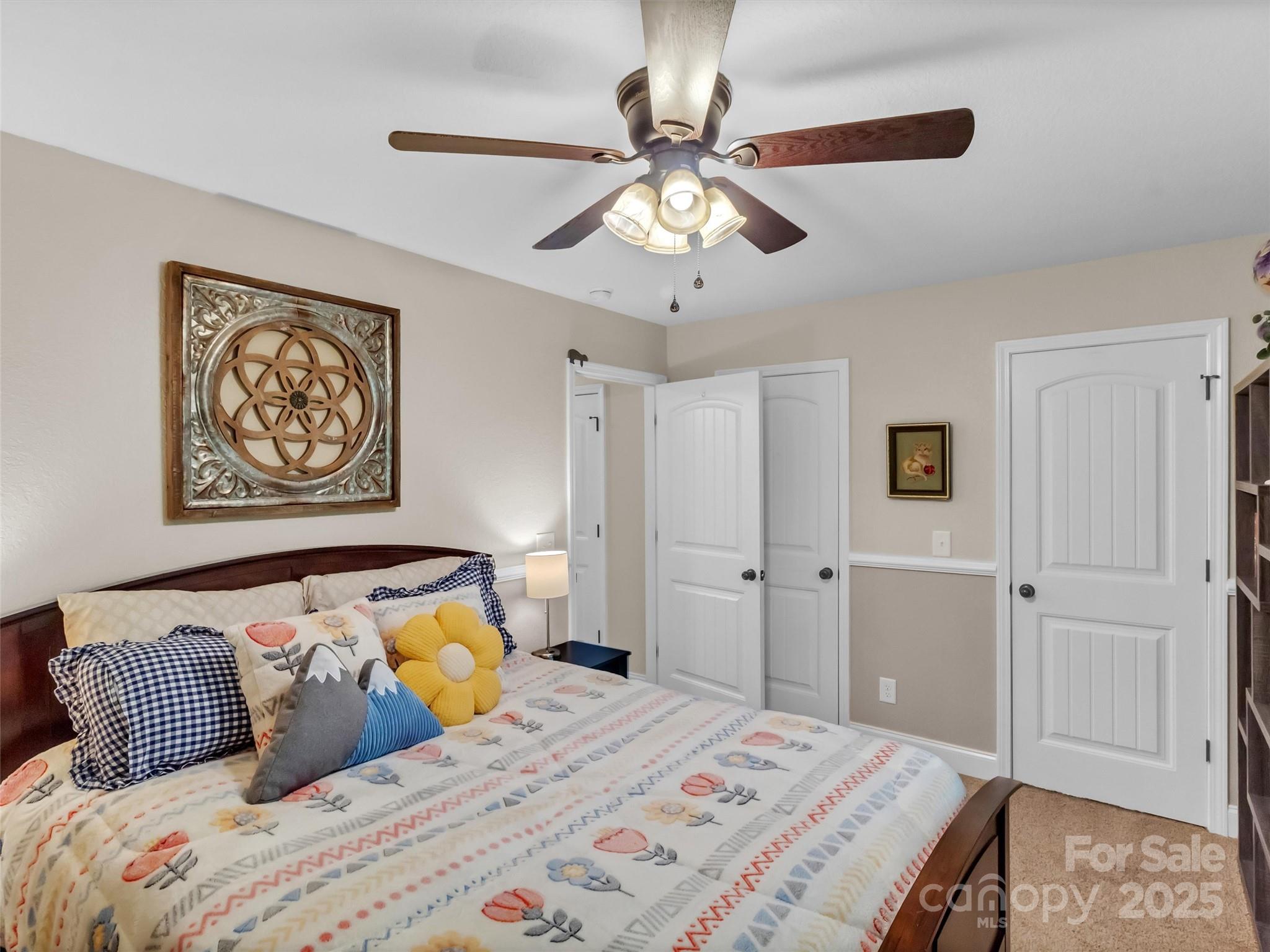 4823 Max Patch Road Clyde, NC 28721 - Photo 18 of 47 a bedroom with a large bed and a chandelier