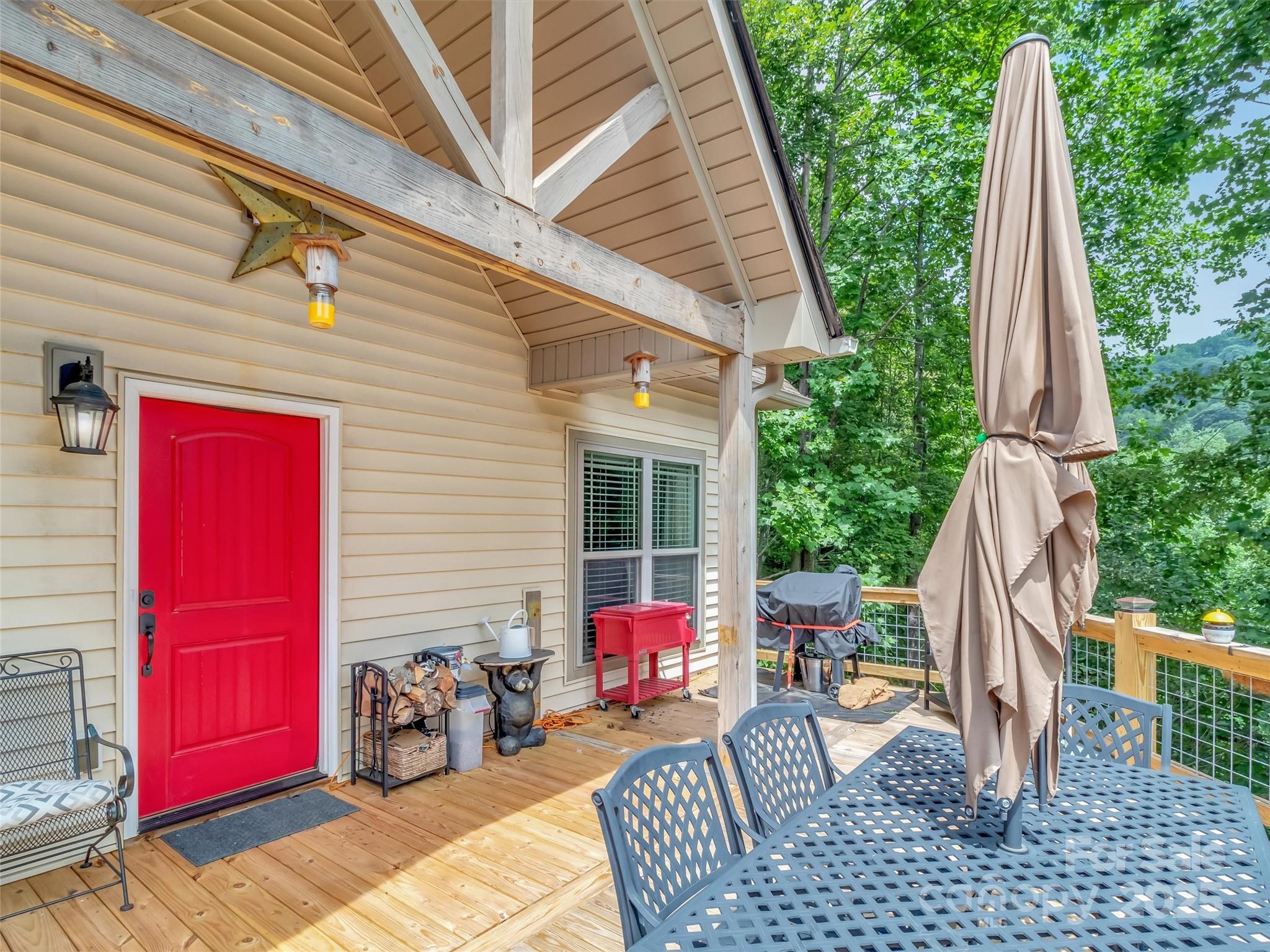 4823 Max Patch Road Clyde, NC 28721 - Photo 27 of 47 a view of backyard with a deck and furniture